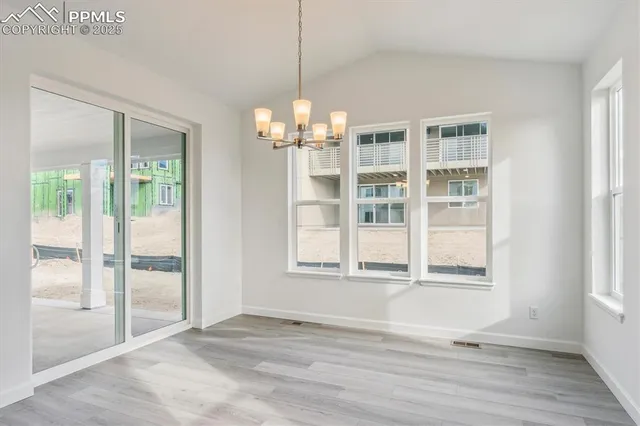 an empty room with wooden floor and a window
