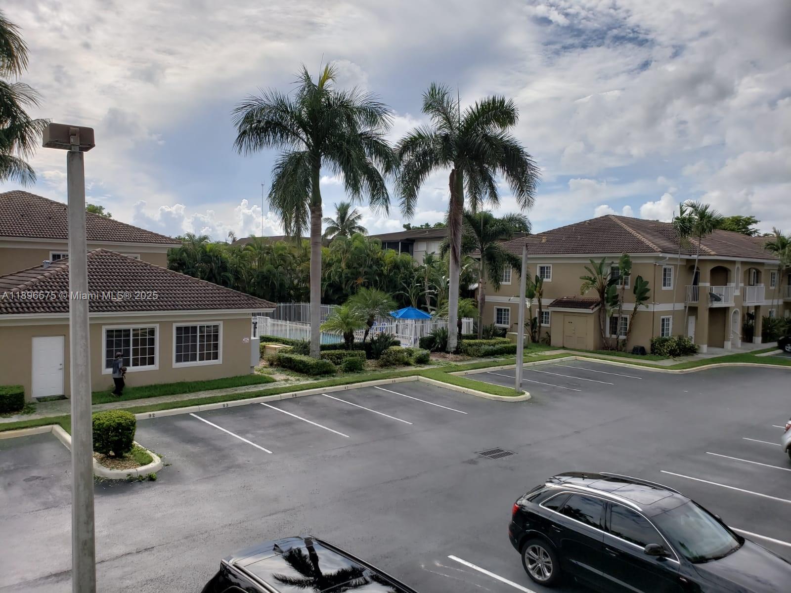 4950 Washington Street, Unit 5 Hollywood, FL 33021 - Photo 1 of 19 a view of a car in front of a house