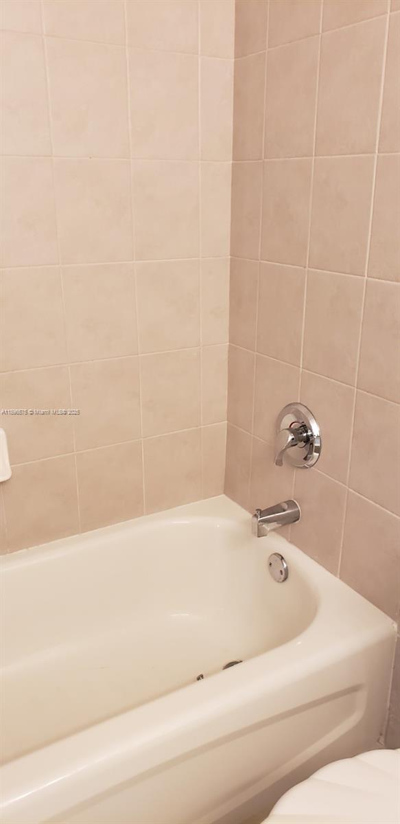 4950 Washington Street, Unit 5 Hollywood, FL 33021 - Photo 11 of 19 a bathroom with a bathtub
