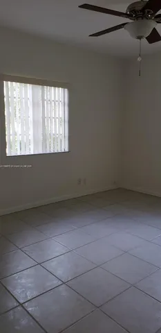 a a room with a window and a ceiling fan