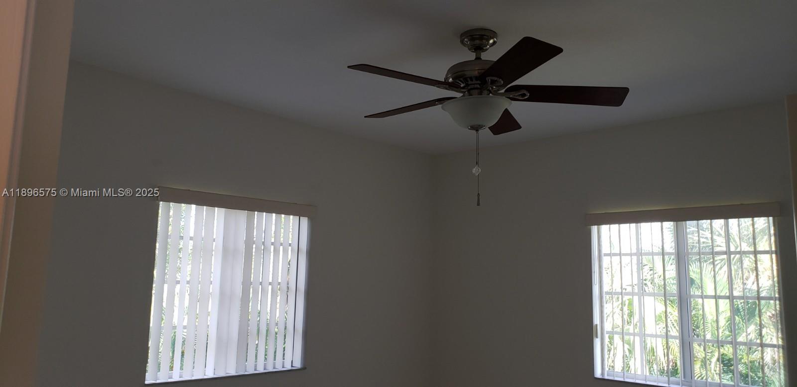 4950 Washington Street, Unit 5 Hollywood, FL 33021 - Photo 16 of 19 a a room with a window and a ceiling fan