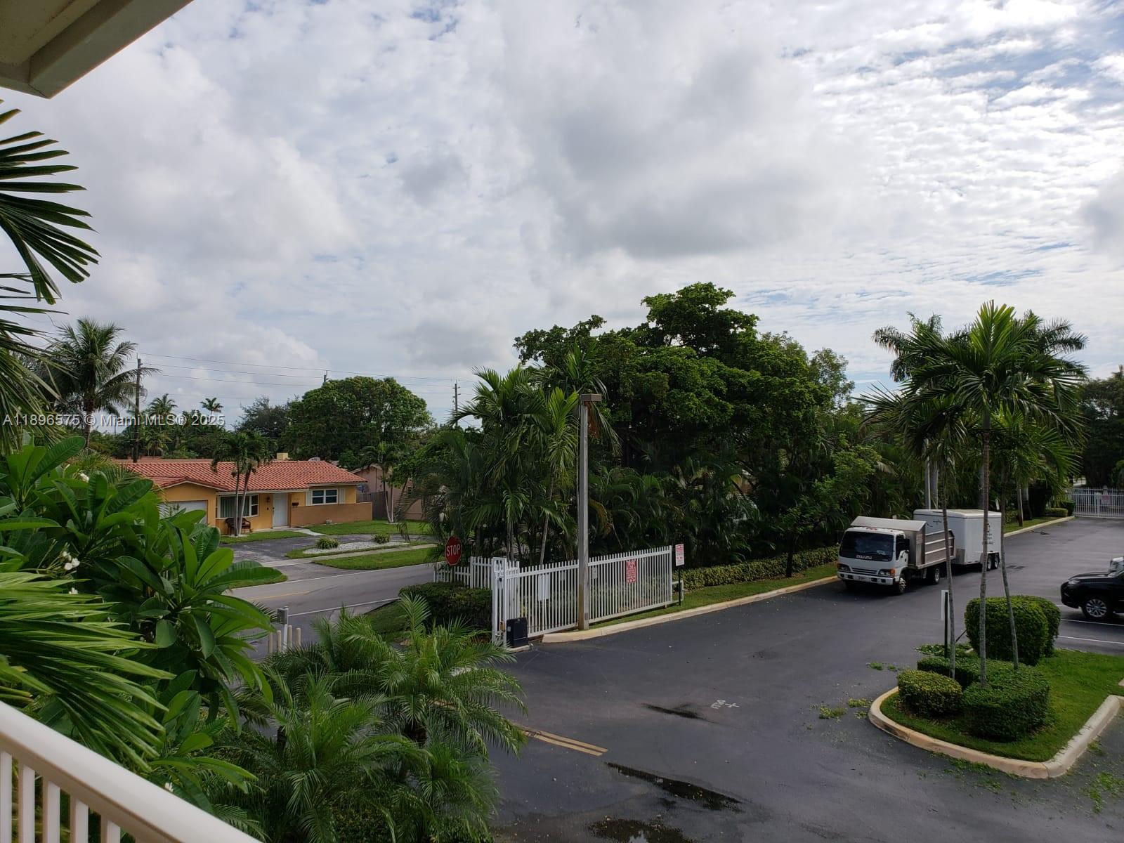 4950 Washington Street, Unit 5 Hollywood, FL 33021 - Photo 2 of 19 a view of a city street with parked cars