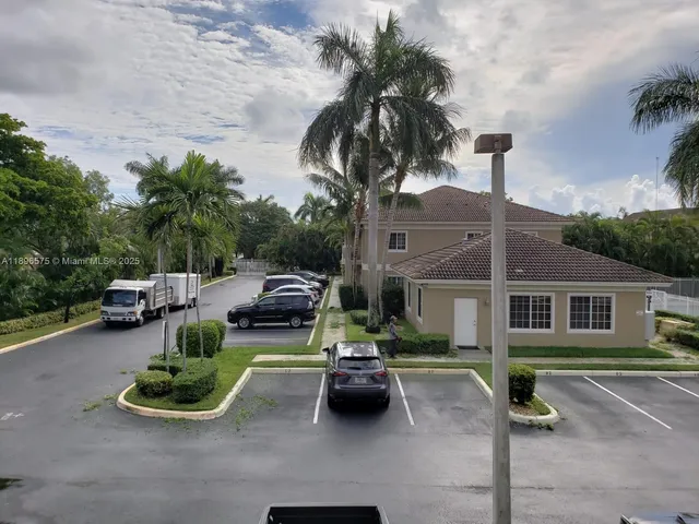 an aerial view of a house with garden and parking space