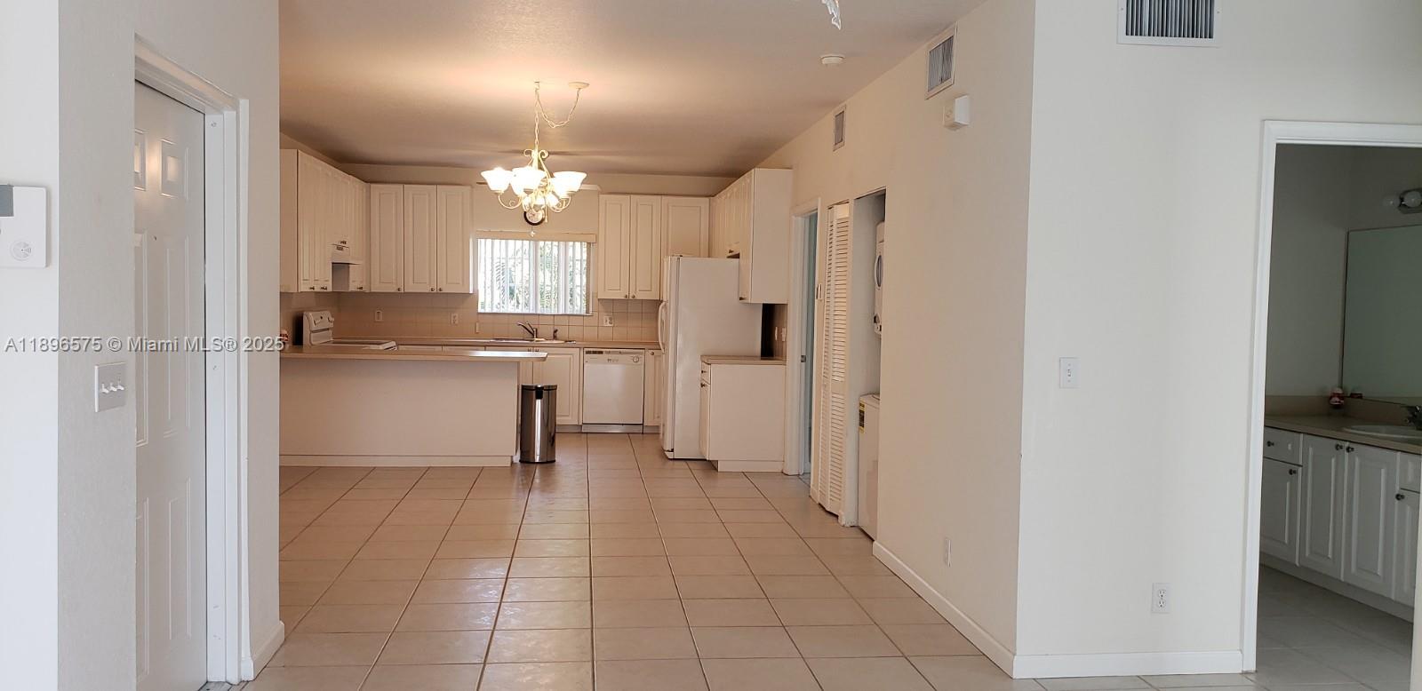4950 Washington Street, Unit 5 Hollywood, FL 33021 - Photo 5 of 19 a view of a kitchen with a refrigerator and a sink