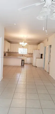 a kitchen with stainless steel appliances granite countertop a sink a stove and a window