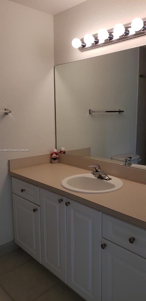 4950 Washington Street, Unit 5 Hollywood, FL 33021 - Photo 9 of 19 a bathroom with a sink and vanity
