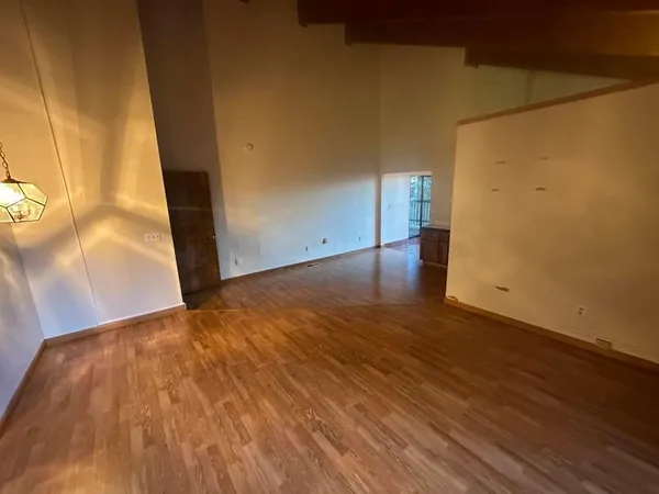 an empty room with windows and closet