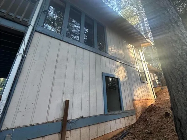 a view of balcony with wooden door and deck