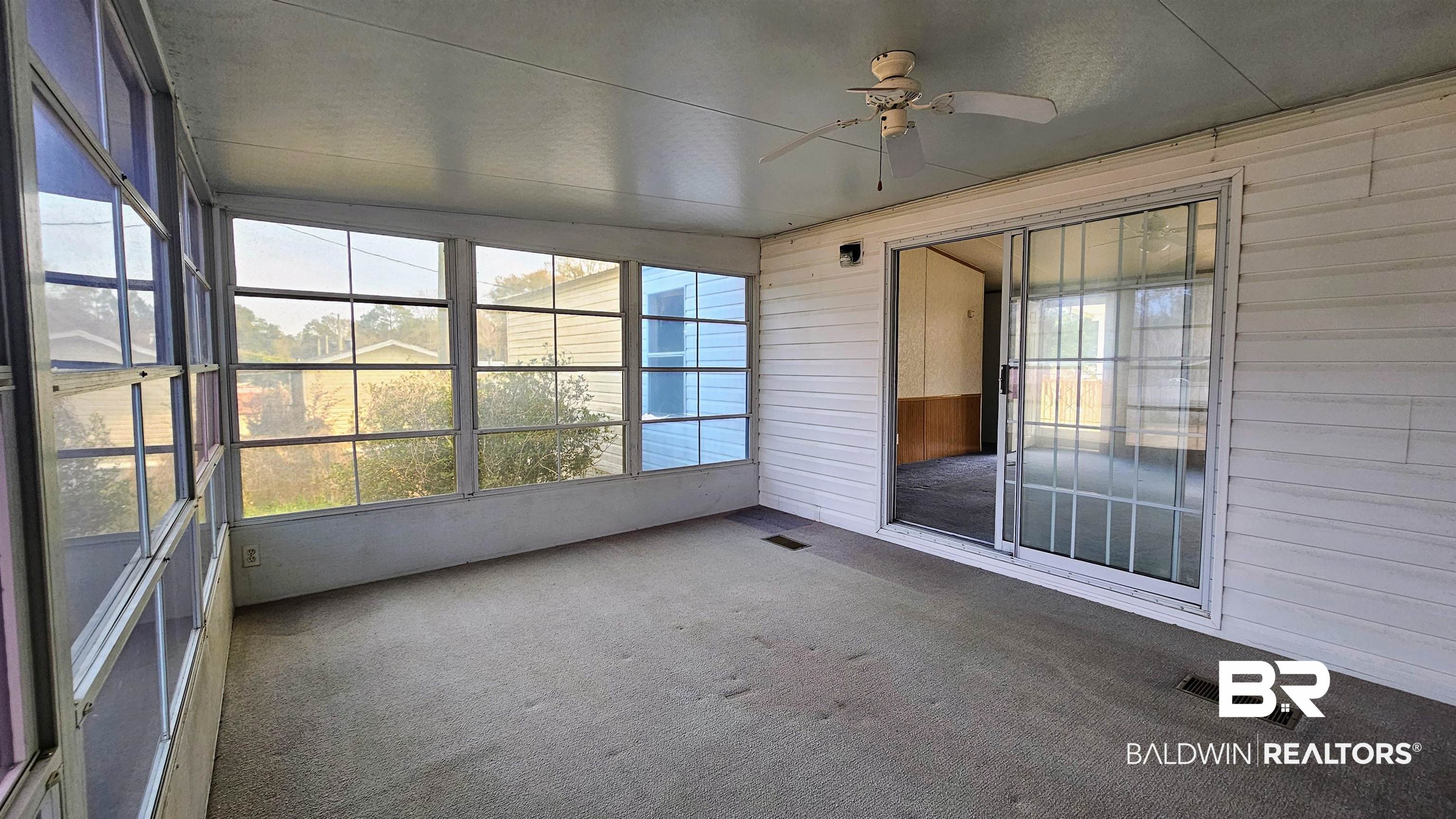 18659 Bull Springs Road Robertsdale, AL 36567 - Photo 18 of 25 Unfurnished sunroom featuring ceiling fan and a healthy amount of sunlight