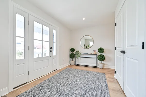a view of a livingroom with wooden floor and a potted plant