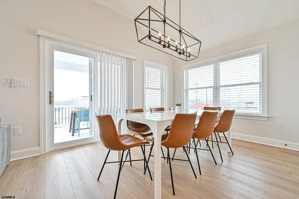 a view of a dining room with furniture wooden floor and a chandelier