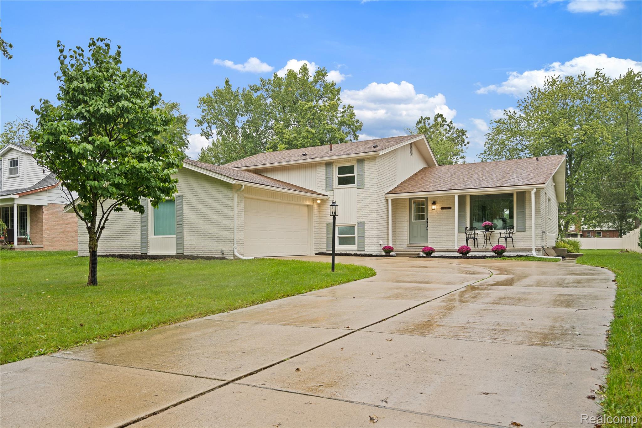 8240 Hampton Road Grosse Ile, MI 48138 - Photo 1 of 33 Exterior featuring a covered entryway, attached garage, and a concrete driveway