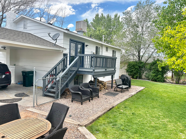 570 250 East Parowan, UT 84761 - Photo 24 of 27 Expansive backyard featuring a manicured lawn, a gravel patio, and mature trees