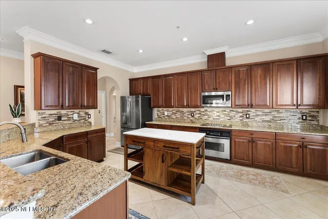 a kitchen with stainless steel appliances granite countertop a stove a sink dishwasher a oven and a refrigerator
