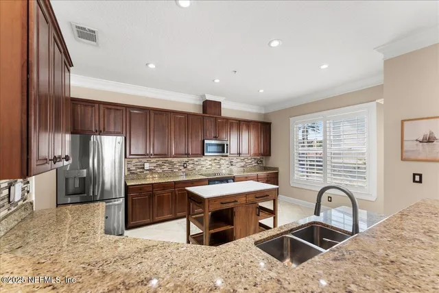 a kitchen with a dining table chairs and view living room