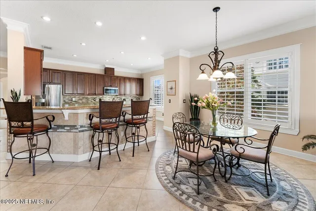 a living room with furniture a flat screen tv and a floor to ceiling window