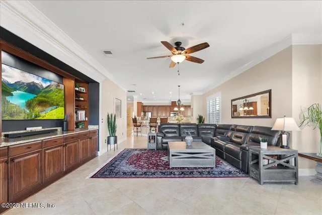 a view of a livingroom and a dining room with furniture window and outside view