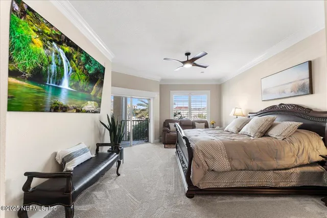 a spacious bedroom with a bed a chandelier and a potted plant
