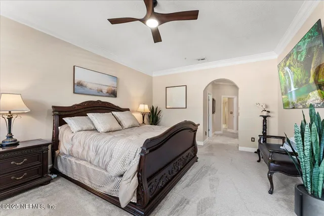 a spacious bedroom with a bed and a couch