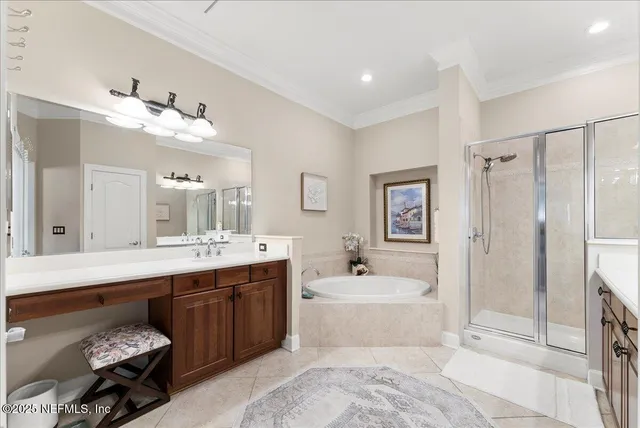 a spacious bathroom with a tub sink and mirror