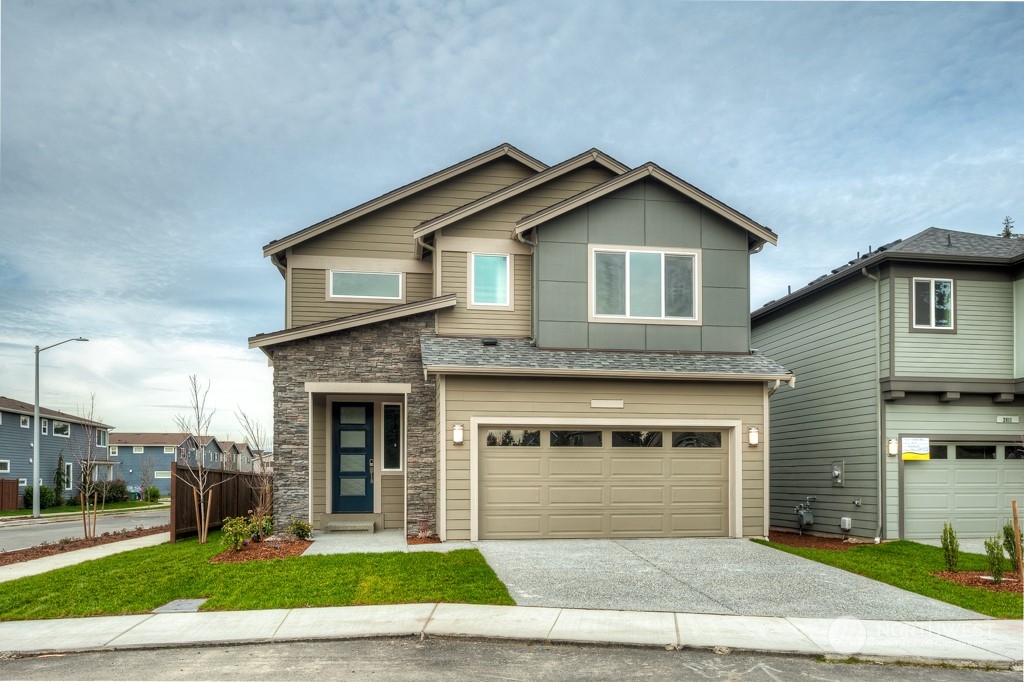 24 178th Place Southwest, Unit IW 64 Bothell, WA 98012 - Photo 1 of 32 a front view of a house with a yard and garage