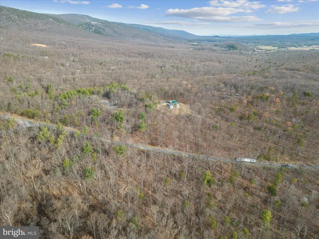 a view of a dry yard with wooden fence