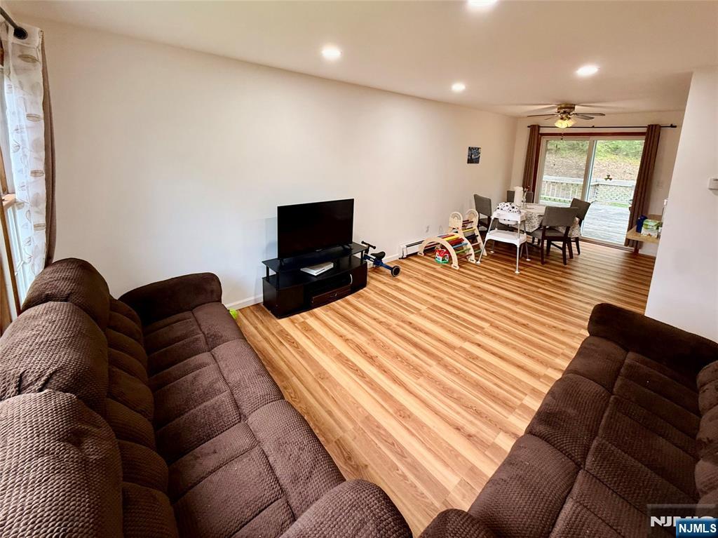 154 Cork Hill Road Franklin, NJ 07416 - Photo 2 of 35 a living room with furniture and a flat screen tv