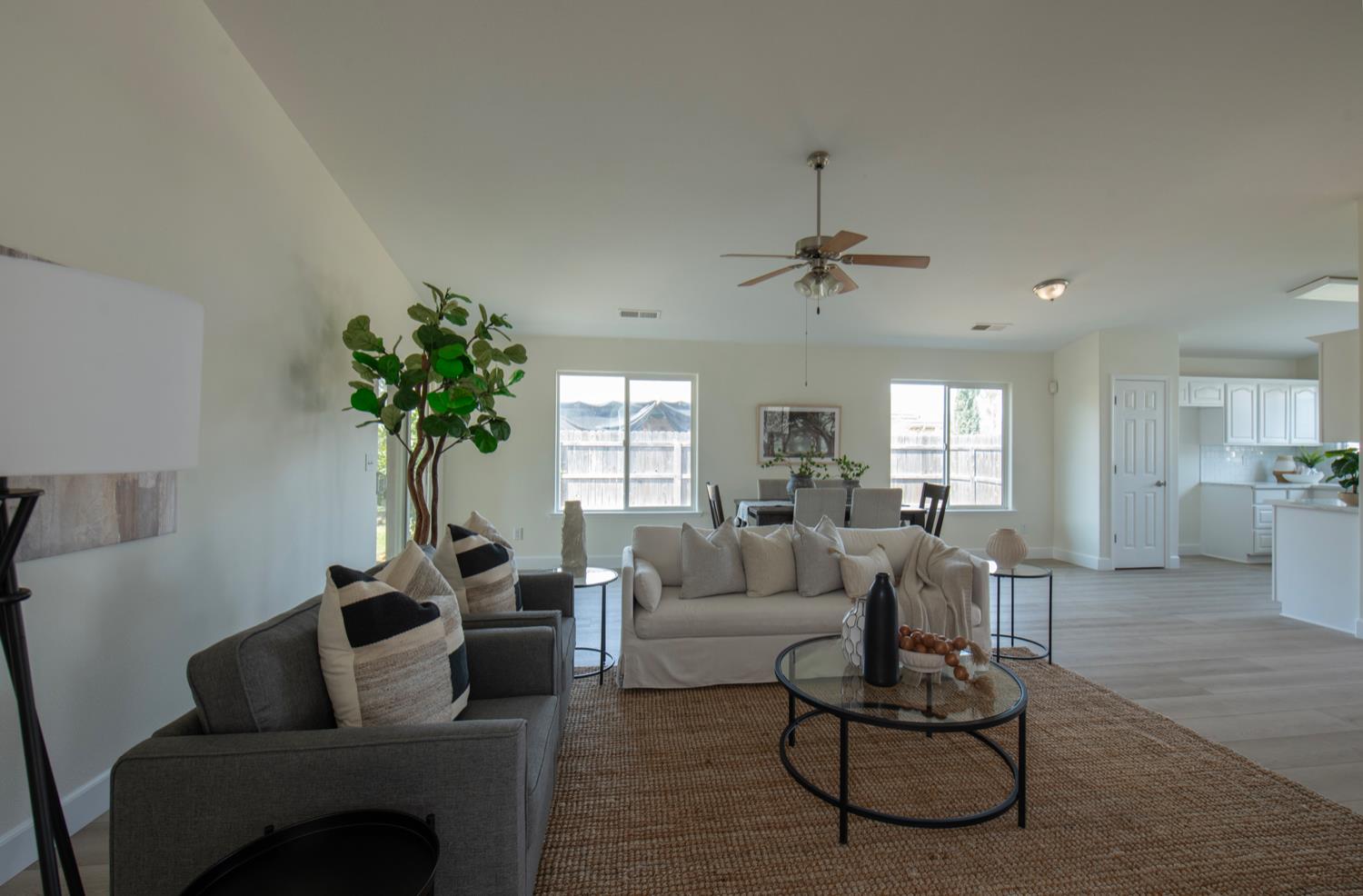 440 Pine Street Parlier, CA 93648 - Photo 14 of 27 a living room with furniture a chandelier and a window