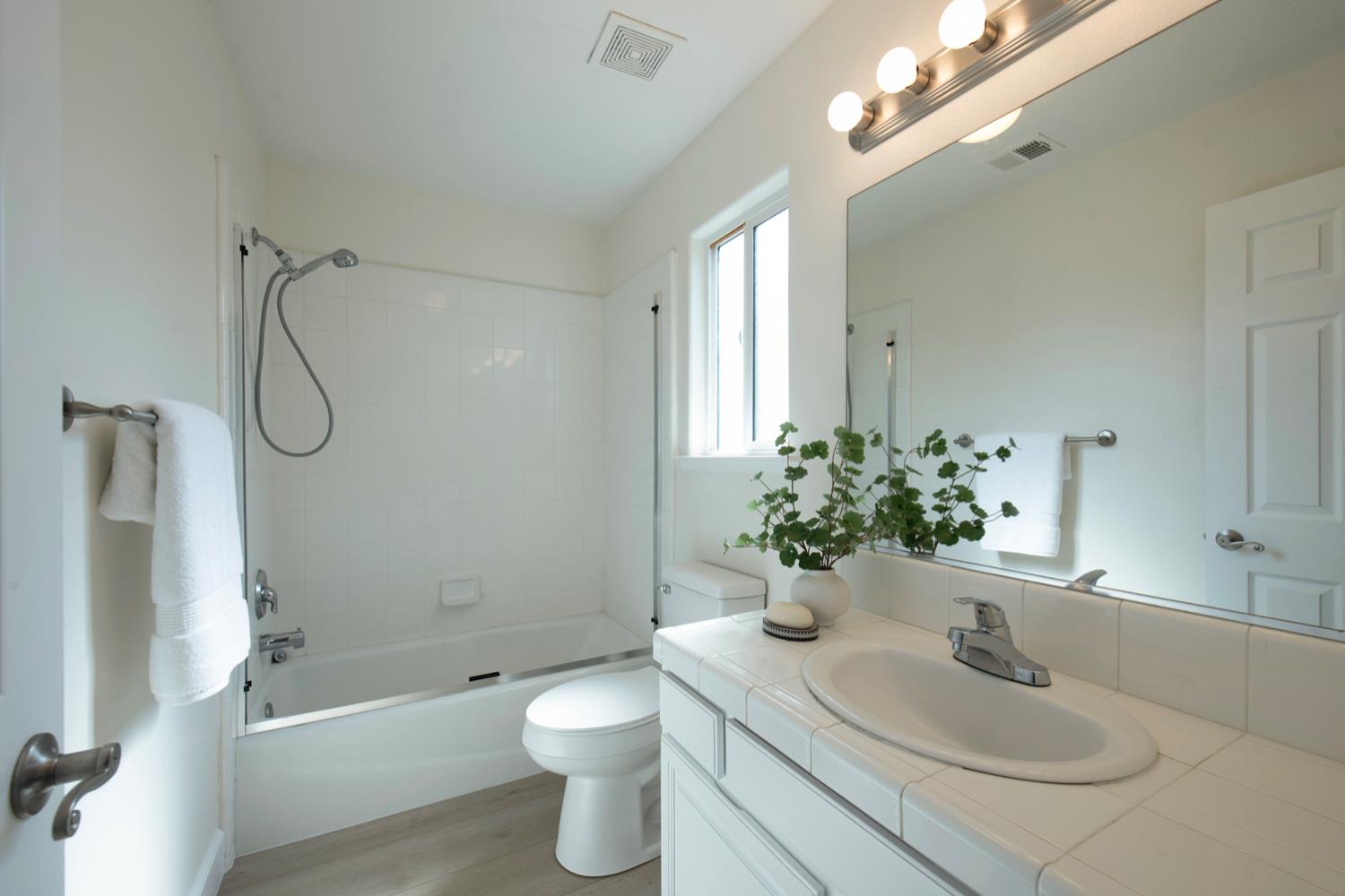 440 Pine Street Parlier, CA 93648 - Photo 21 of 27 a bathroom with a sink toilet a shower and a mirror