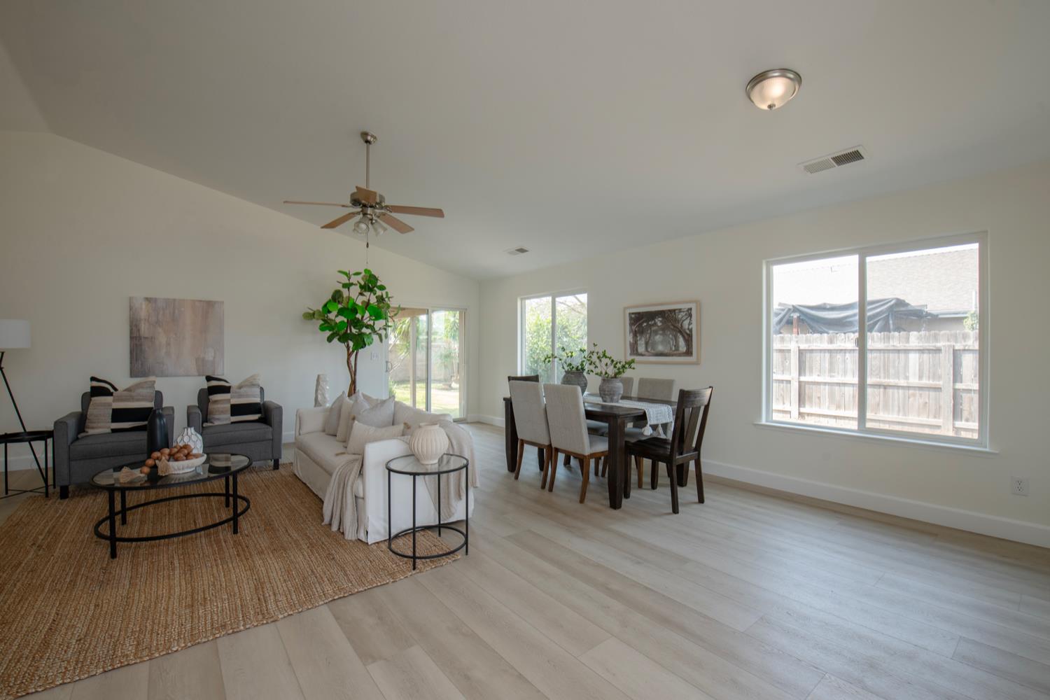 440 Pine Street Parlier, CA 93648 - Photo 4 of 27 a living room with furniture dining table and a wooden floor