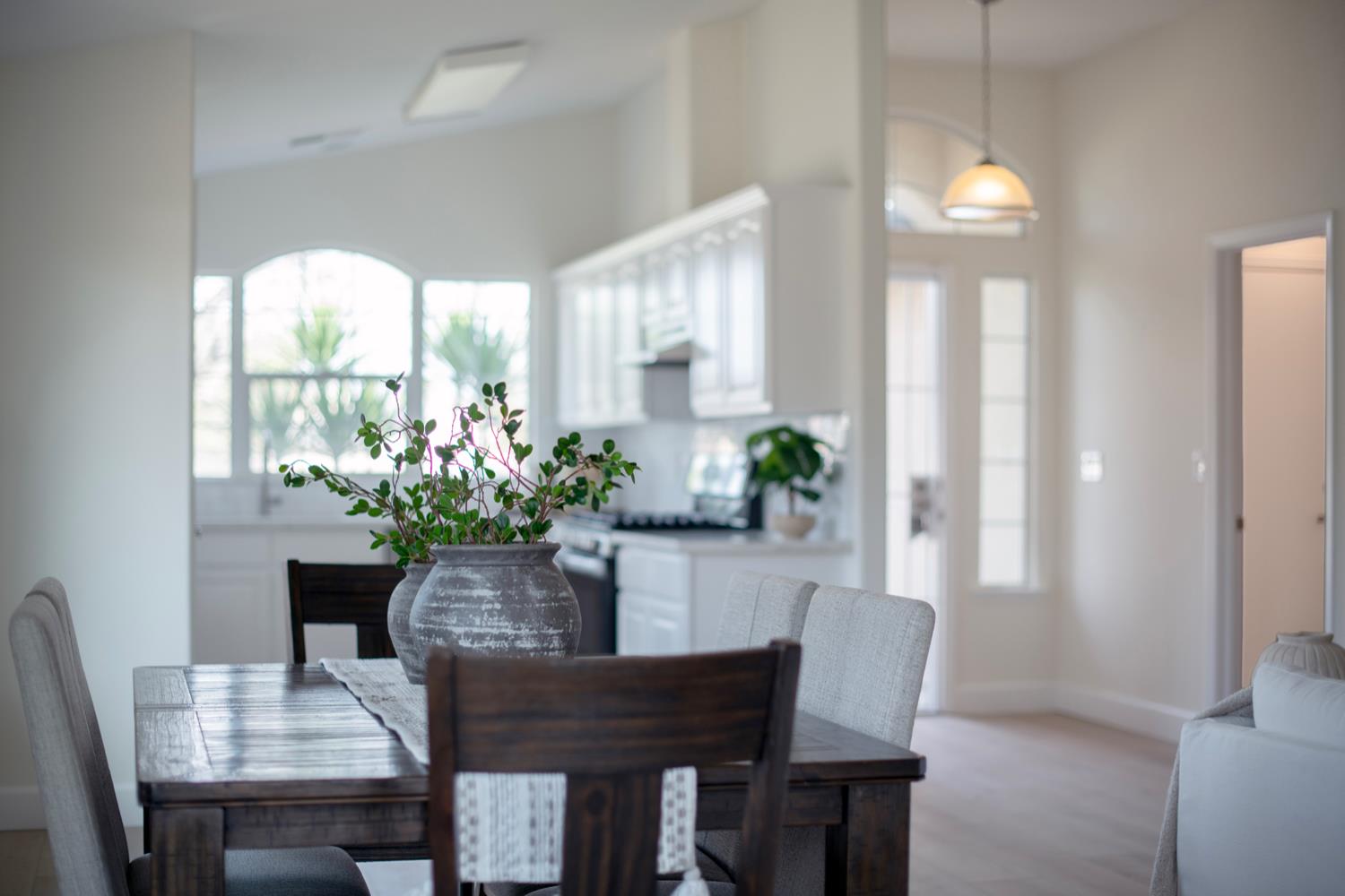 440 Pine Street Parlier, CA 93648 - Photo 5 of 27 a dining room with furniture potted plants and wooden floor