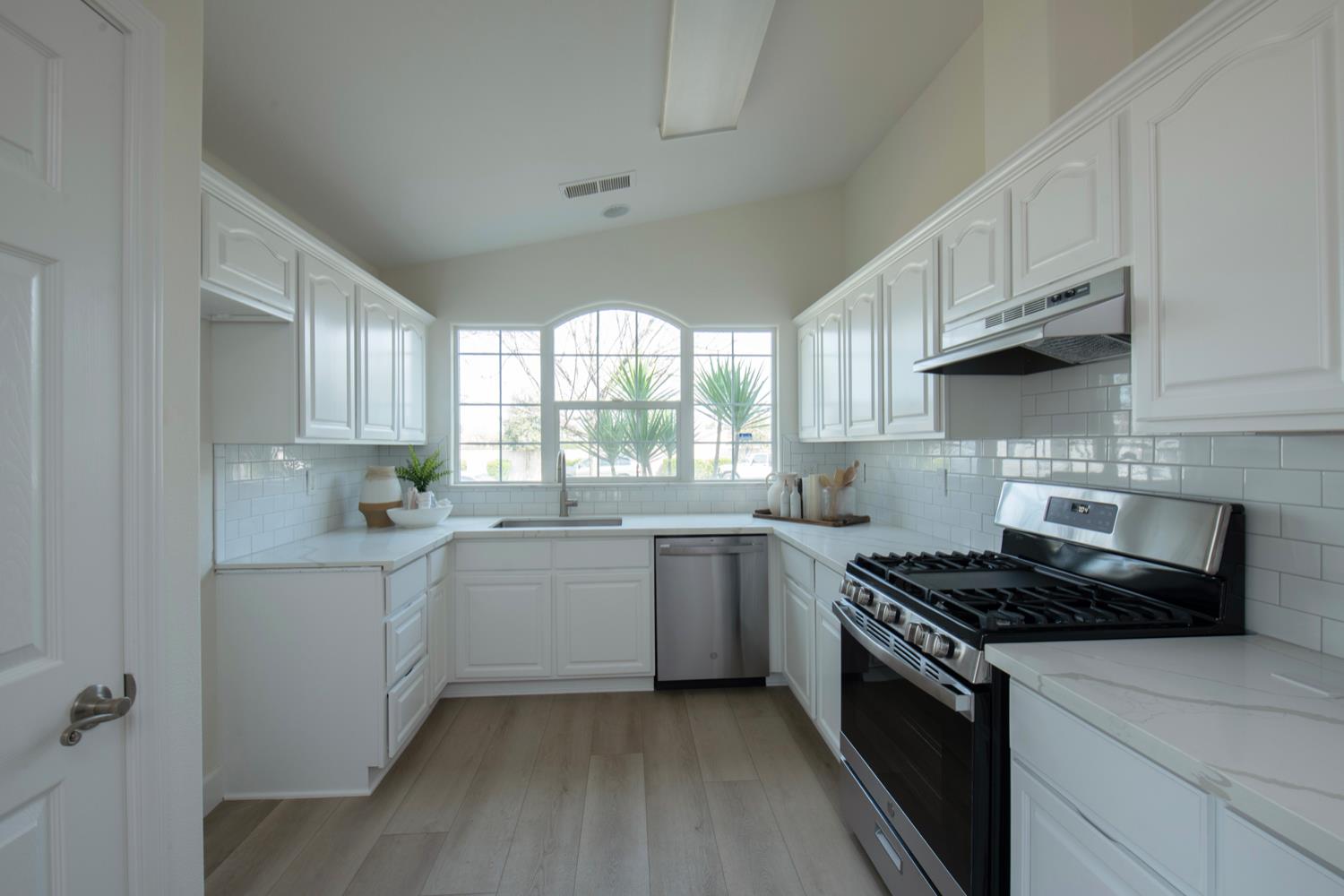 440 Pine Street Parlier, CA 93648 - Photo 6 of 27 a kitchen with a sink stove top oven and cabinets