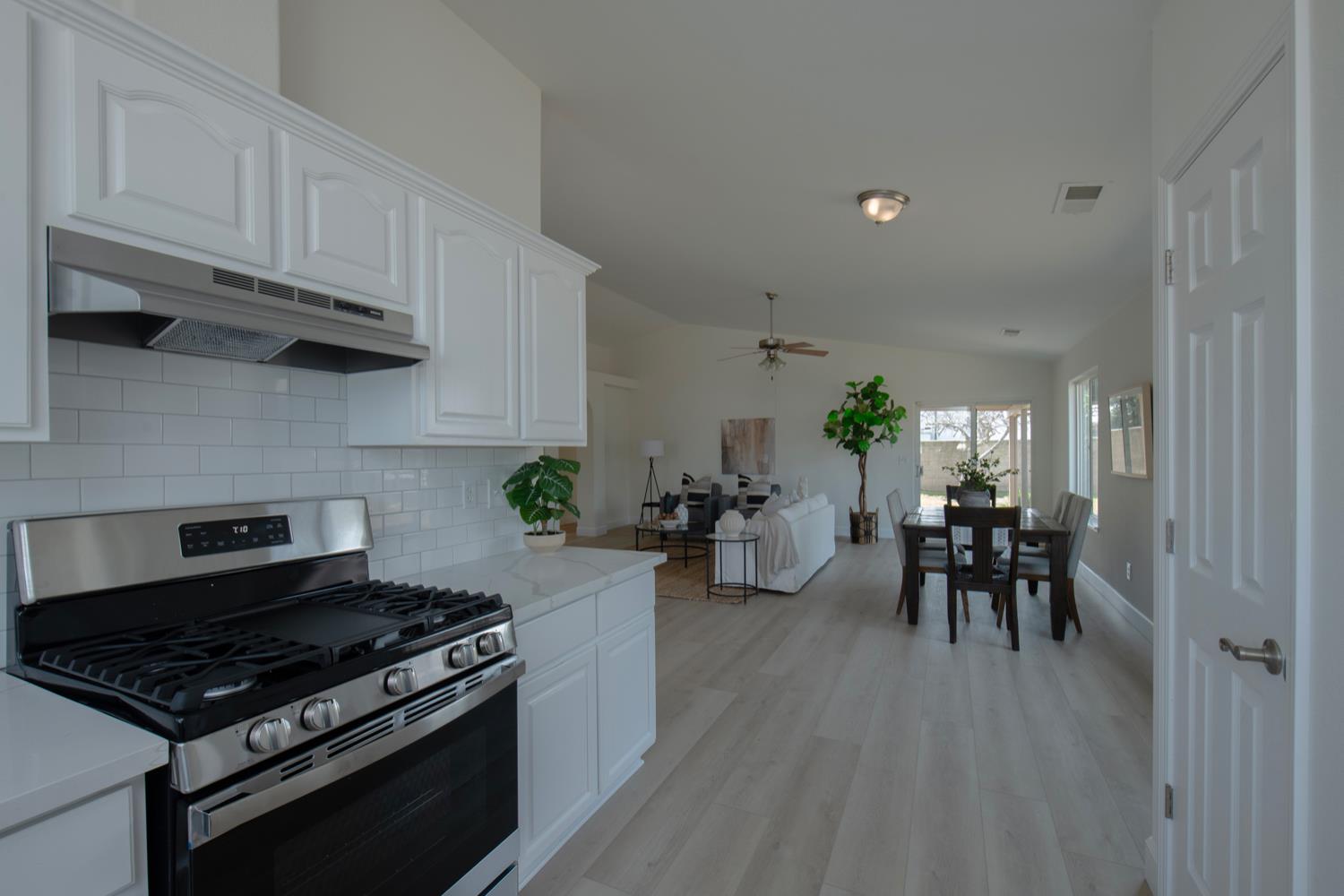 440 Pine Street Parlier, CA 93648 - Photo 9 of 27 a kitchen with stainless steel appliances granite countertop a stove and a refrigerator