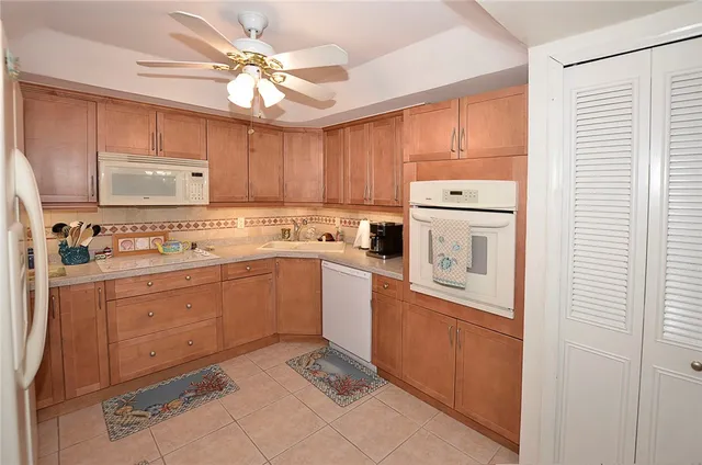 a kitchen with a stove sink and cabinets