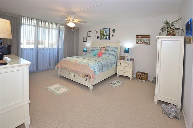 a bedroom with a bed and a refrigerator