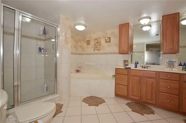 a bathroom with a double vanity sink a mirror and a bathtub
