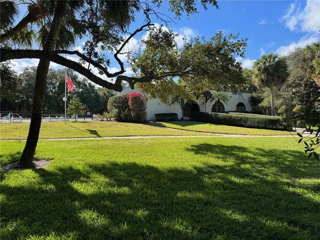 a view of a house with a tree in front of it
