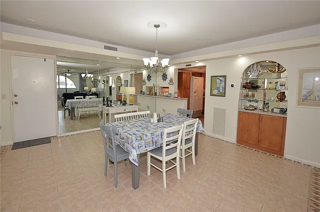 a dining room with furniture and chandelier or kitchen view