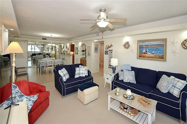 a living room with furniture fireplace and a view of kitchen