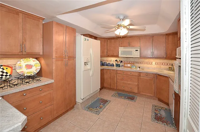 a kitchen with a stove cabinets and a refrigerator