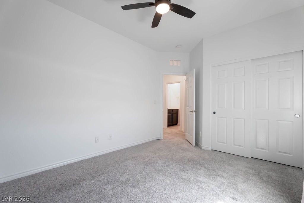 7126 Calvert Cliffs Street North Las Vegas, NV 89084 - Photo 36 of 44 A comfortable bedroom features plush carpeting and a convenient ceiling fan.