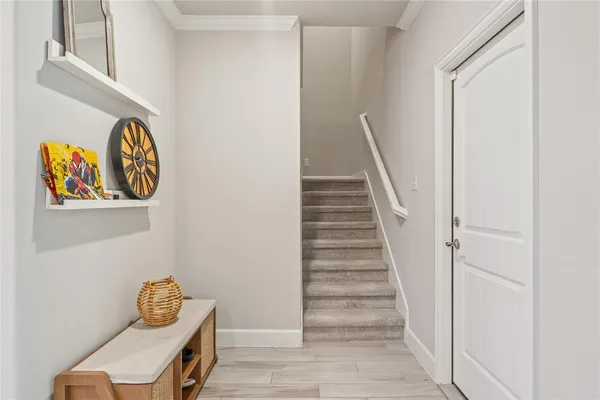 a view of room with stairs and wooden floor