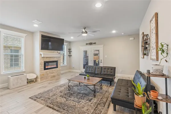 a living room with furniture a fireplace and a flat screen tv