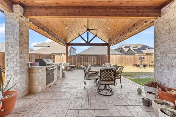 a outdoor space with lots of tables a chairs and a barbeque