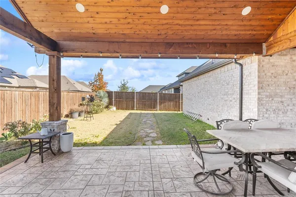 a building outdoor space with patio furniture and potted plants