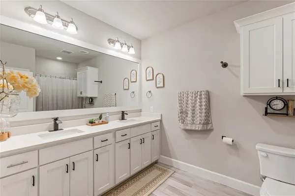 a spacious bathroom with a double vanity sink mirror and