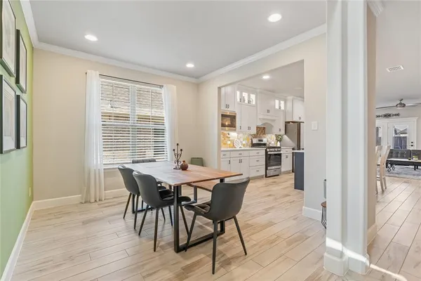 a view of a dining room with furniture and wooden floor