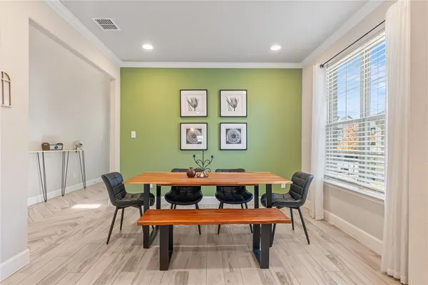 a view of a dining room with furniture and wooden floor