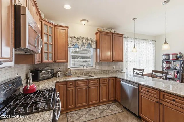 a kitchen with a sink stove and cabinets