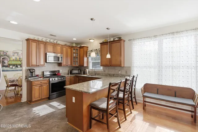 a kitchen with stainless steel appliances granite countertop a stove and a refrigerator